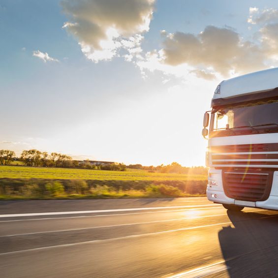 Truck with container on road, cargo transportation concept. Truck with container on highway, cargo transportation concept. Shaving effect.