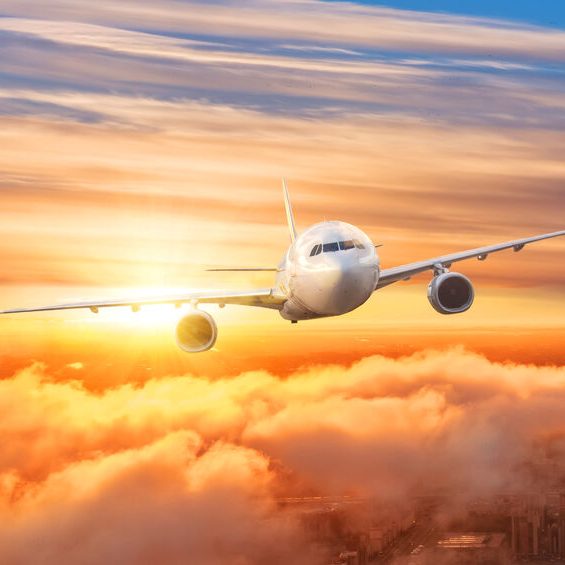 Airplane above the clouds in the sky at sunrise. Airplane above the clouds in the sky at sunrise