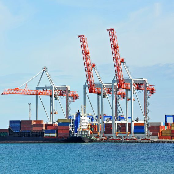 Cargo crane and ship Container stack and ship under crane bridge